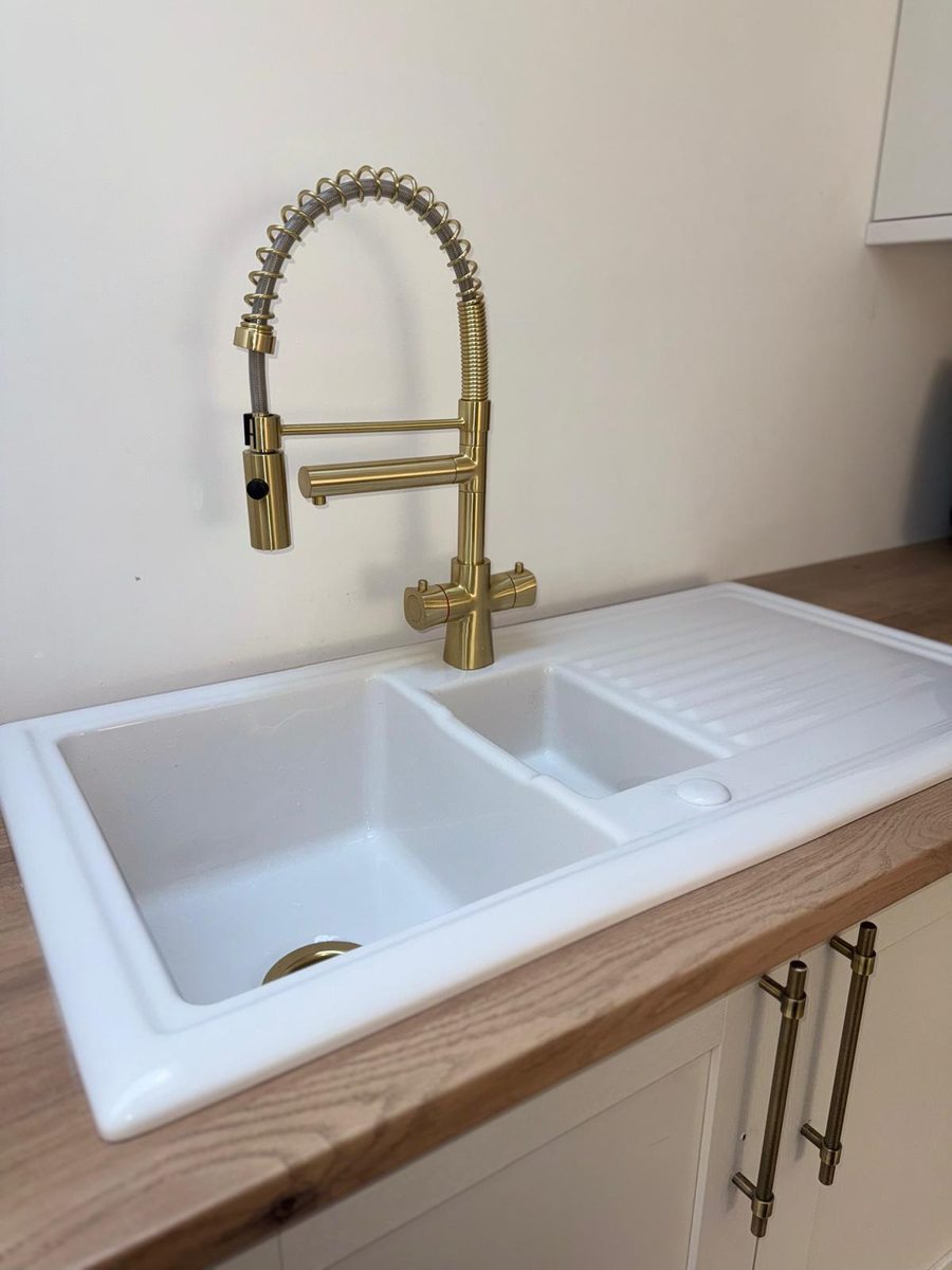 Kitchen sink and brass tap